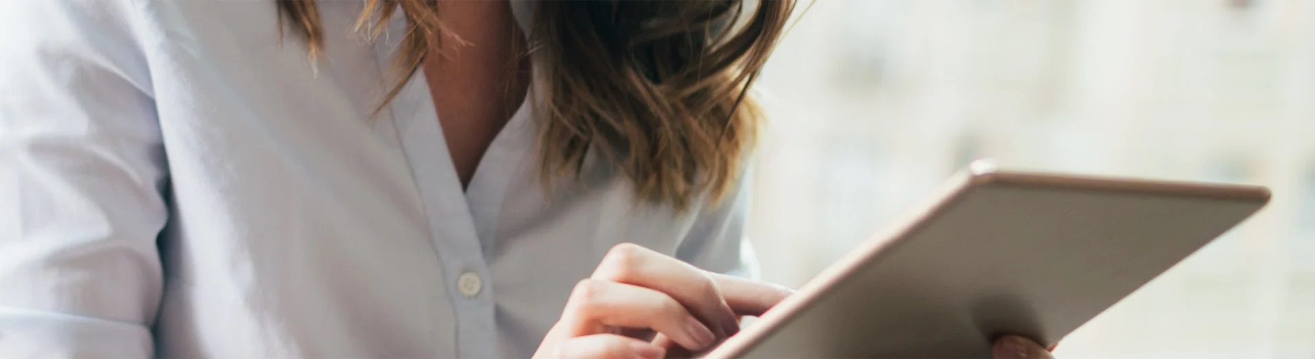 A woman using a tablet.